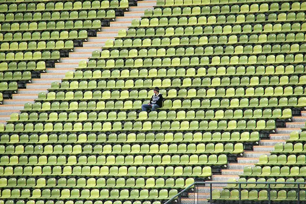 Man sitting alone in stadium